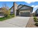 Charming home with a stone chimney, three-car garage, and well-manicured front yard at 3429 Goodyear St, Castle Rock, CO 80109