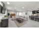 Open concept living room with neutral tones and a large comfortable sectional sofa. Includes a wet bar area at 3429 Goodyear St, Castle Rock, CO 80109