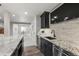 Stylish wet bar area featuring granite countertops, dark cabinets, and a convenient wine cooler at 3429 Goodyear St, Castle Rock, CO 80109