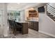 Basement wet bar includes seating for four, wine storage and beverage center perfect for entertaining at 2136 S Juniper St, Lakewood, CO 80228