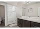 Bathroom featuring walk-in shower, with dual shower heads, and modern vanity with plenty of counterspace at 2136 S Juniper St, Lakewood, CO 80228