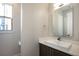Clean half-bathroom featuring a modern sink, vanity, and mirror at 2136 S Juniper St, Lakewood, CO 80228