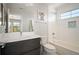 Modern bathroom with a sleek vanity, bathtub, and shower with white subway tile surround at 2136 S Juniper St, Lakewood, CO 80228