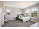 Inviting bedroom featuring three windows, a soft bed, and neutral decor for a serene atmosphere at 2136 S Juniper St, Lakewood, CO 80228