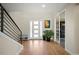 Inviting foyer with hardwood floors, a modern staircase, and a view into an office space at 2136 S Juniper St, Lakewood, CO 80228