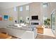 Bright living room featuring high ceilings, modern fireplace, and access to a patio at 2136 S Juniper St, Lakewood, CO 80228