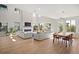Open-concept living room with fireplace and large windows for natural light at 2136 S Juniper St, Lakewood, CO 80228