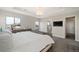 Well-lit main bedroom with an en-suite bathroom, dresser and views of the patio and neighborhood at 2136 S Juniper St, Lakewood, CO 80228