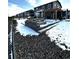 Backyard patio featuring a stone fire pit, a built-in barbeque area, and a pergola at 7435 E 159Th Pl, Thornton, CO 80602