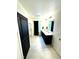 Well-lit bathroom featuring a double vanity, tiled floors, and a glass-enclosed shower at 7435 E 159Th Pl, Thornton, CO 80602