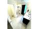 Bright bathroom with double sinks, tiled floors, and a glass shower enclosure at 7435 E 159Th Pl, Thornton, CO 80602