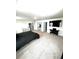 Spacious bedroom with wall mounted television, neutral carpet and access to multiple doors at 7435 E 159Th Pl, Thornton, CO 80602
