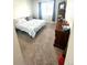 Bright bedroom with a comfortable bed, dark wood dresser, and a large window providing natural light at 7435 E 159Th Pl, Thornton, CO 80602