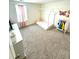 Cozy carpeted bedroom with a unique playhouse bed frame and bright decor at 7435 E 159Th Pl, Thornton, CO 80602