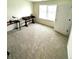 Bedroom with carpeted floor, large window and desk at 7435 E 159Th Pl, Thornton, CO 80602
