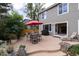 Inviting backyard with a patio, outdoor dining, grill, lush landscaping, and a cozy lounge chair at 9170 Fox Fire Dr, Highlands Ranch, CO 80129