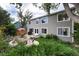 Exterior view of home showcasing a patio, outdoor dining, lush landscaping, and well-maintained yard at 9170 Fox Fire Dr, Highlands Ranch, CO 80129
