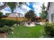 Large backyard featuring a patio, outdoor seating, lush lawn, and mature trees, perfect for outdoor living at 9170 Fox Fire Dr, Highlands Ranch, CO 80129