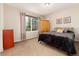 Inviting bedroom with a large window, wood wardrobe, dresser, and comfortable bed with colorful pillows at 9170 Fox Fire Dr, Highlands Ranch, CO 80129