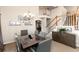 Dining room featuring stairs, dark table, and modern decor at 9170 Fox Fire Dr, Highlands Ranch, CO 80129