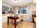 The dining room features a wood table with seating and a window that provides natural light at 9170 Fox Fire Dr, Highlands Ranch, CO 80129
