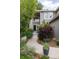 Exterior view shows a walkway leading to the home's entrance, surrounded by lush landscaping, bushes, and greenery at 9170 Fox Fire Dr, Highlands Ranch, CO 80129