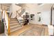 This foyer boasts hardwood floors, a staircase, and ample natural light, complemented by a view to an office space at 9170 Fox Fire Dr, Highlands Ranch, CO 80129
