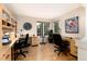 Bright home office with wood floors, built-in desk, and natural light from the window at 9170 Fox Fire Dr, Highlands Ranch, CO 80129