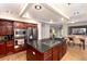 This updated kitchen features a large island with seating, granite countertops, and stainless steel appliances at 9170 Fox Fire Dr, Highlands Ranch, CO 80129