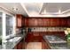Kitchen features granite countertops, stainless appliances, stylish backsplash, and wood cabinets at 9170 Fox Fire Dr, Highlands Ranch, CO 80129