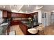 This updated kitchen features a large island with seating, granite countertops, and stainless steel appliances at 9170 Fox Fire Dr, Highlands Ranch, CO 80129