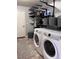 Practical laundry room with shelving, front load washer and dryer at 9170 Fox Fire Dr, Highlands Ranch, CO 80129