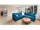 The open concept living room features a comfortable sectional sofa and access to the outdoor living at 9170 Fox Fire Dr, Highlands Ranch, CO 80129