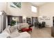 Spacious living area with high ceilings, comfortable seating, and a dining area, illuminated by natural light at 9170 Fox Fire Dr, Highlands Ranch, CO 80129