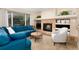 This cozy living room is anchored by a stone fireplace and features a comfortable blue sofa at 9170 Fox Fire Dr, Highlands Ranch, CO 80129