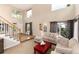 Bright living room with high ceilings, comfortable seating, and abundant natural light at 9170 Fox Fire Dr, Highlands Ranch, CO 80129