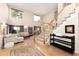 Sunlit living room featuring hardwood floors, staircase, neutral walls, and comfortable seating arrangement at 9170 Fox Fire Dr, Highlands Ranch, CO 80129