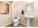 Cozy powder room featuring a pedestal sink and neutral decor at 9170 Fox Fire Dr, Highlands Ranch, CO 80129