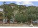 Exterior view of Silver Queen Condominiums with rustic sign and a beautiful mountain view at 1901 Clear Creek Dr # F104, Georgetown, CO 80444