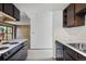 Galley-style kitchen with standard appliances opening into living room with wood paneling and sliding door to balcony at 1901 Clear Creek Dr # F104, Georgetown, CO 80444