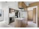 Kitchen with laminate countertop island, basic appliances, and wood look upper cabinets at 1901 Clear Creek Dr # F104, Georgetown, CO 80444