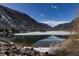 Snowy mountains create a picturesque backdrop for the still lake during daytime at 1901 Clear Creek Dr # F104, Georgetown, CO 80444