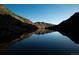 This still lake reflects the scenic mountain landscape during early morning light at 1901 Clear Creek Dr # F104, Georgetown, CO 80444