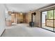 Living room with carpeted floors, wood panel walls, and small wood burning stove next to the sliding door at 1901 Clear Creek Dr # F104, Georgetown, CO 80444