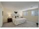 Bright bedroom features neutral walls, soft carpet, and a comfortable king-sized bed with decorative pillows at 12281 E Tennessee Dr # 302, Aurora, CO 80012