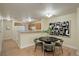 Comfortable dining area with a round table and seating for four adjacent to an open kitchen area, modern decor at 12281 E Tennessee Dr # 302, Aurora, CO 80012