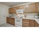Functional kitchen with light wood cabinets, white appliances, and plenty of counter space providing a practical cooking area at 12281 E Tennessee Dr # 302, Aurora, CO 80012