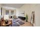 Bright living room with a vaulted ceiling, light wood floors, and neutral-colored walls creates a calm atmosphere at 12281 E Tennessee Dr # 302, Aurora, CO 80012