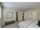 Spacious bedroom with neutral carpet, a comfortable bed, stylish decor, and a view into a walk-in closet at 12281 E Tennessee Dr # 302, Aurora, CO 80012