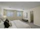 Relaxing bedroom with neutral tones, plush carpet, a comfortable bed, and modern decor, including large windows at 12281 E Tennessee Dr # 302, Aurora, CO 80012